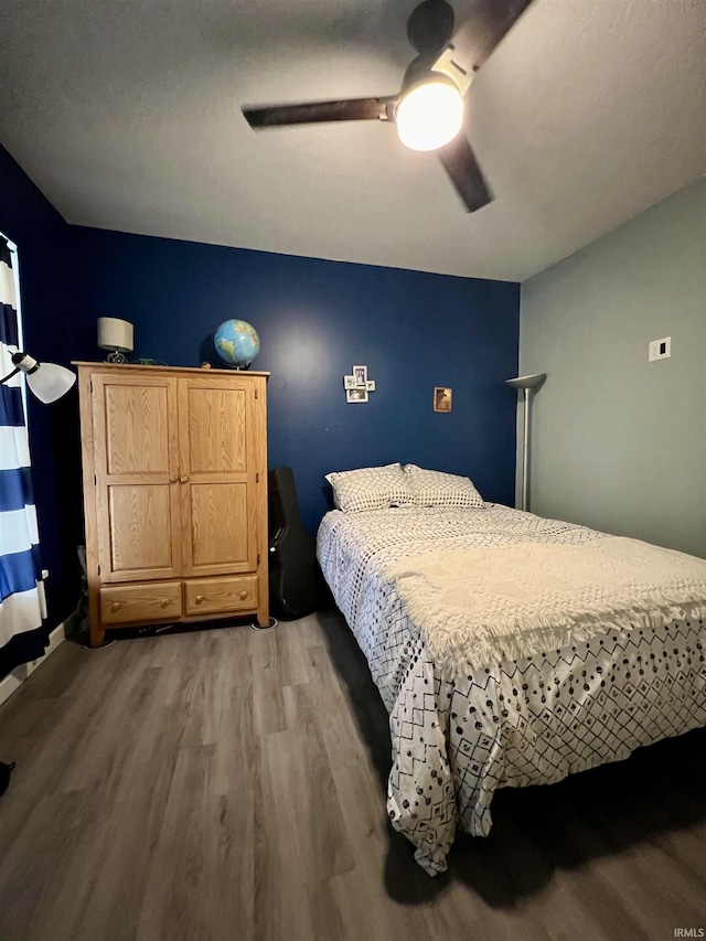 bedroom with ceiling fan and wood-type flooring