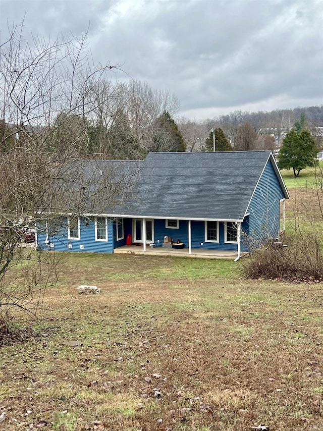 rear view of house featuring a yard and a patio area