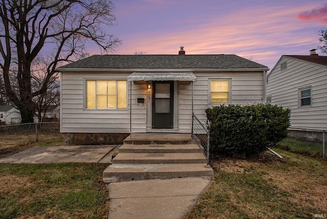 bungalow-style house featuring a lawn