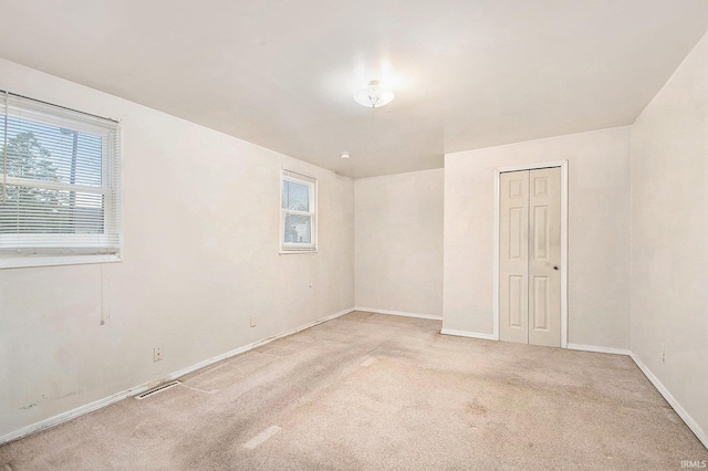 unfurnished room with light colored carpet