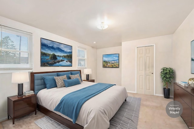 bedroom with light carpet and a closet