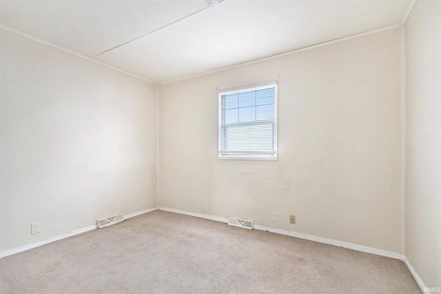 carpeted spare room featuring ornamental molding