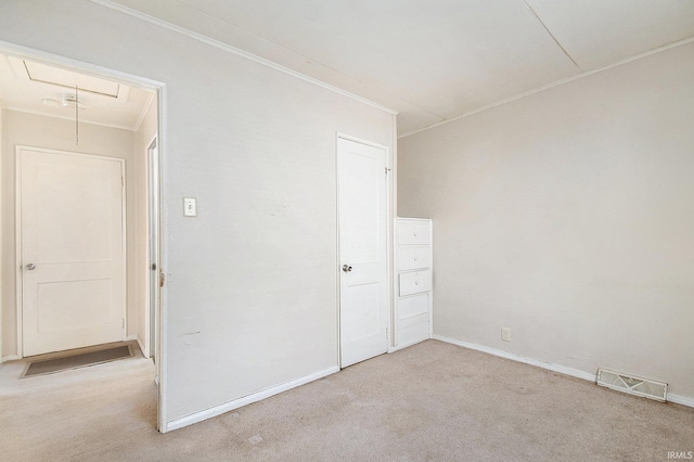 unfurnished room featuring light colored carpet and crown molding