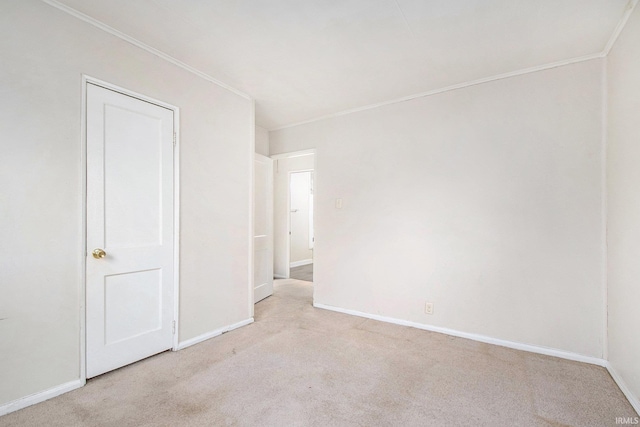 carpeted spare room with crown molding