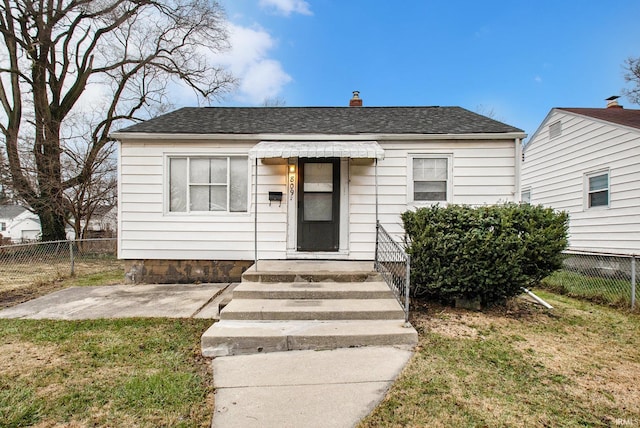 bungalow-style home featuring a front yard