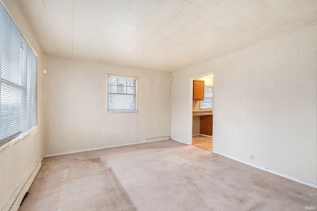 carpeted spare room with a baseboard radiator