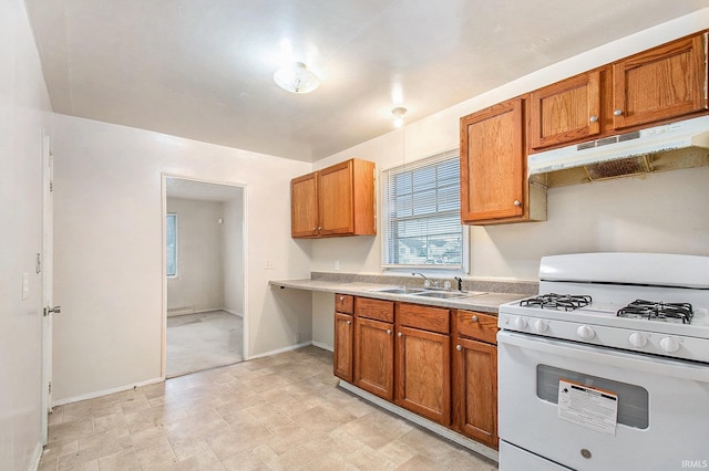 kitchen featuring white range with gas cooktop and sink