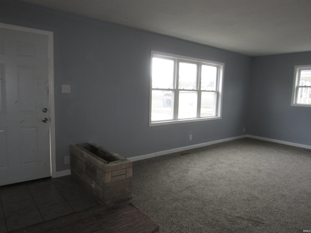 empty room featuring dark carpet