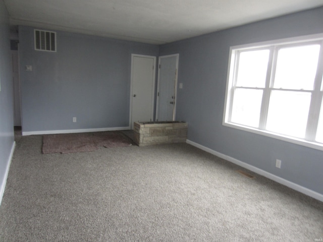 unfurnished living room with carpet flooring