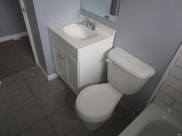 bathroom with tile patterned flooring, vanity, and toilet