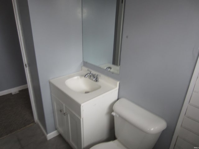 bathroom with tile patterned floors, vanity, and toilet