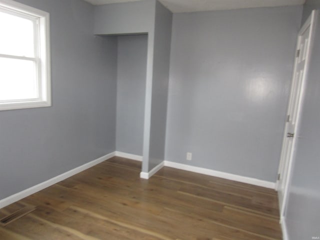 empty room featuring dark wood-type flooring