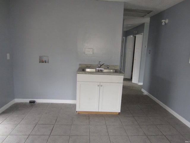 laundry room featuring light tile patterned flooring, washer hookup, and sink