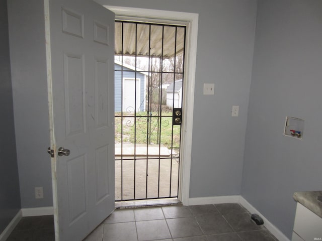 entryway featuring dark tile patterned flooring