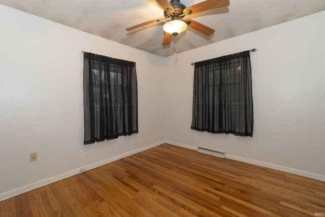 unfurnished room featuring hardwood / wood-style floors, baseboard heating, and ceiling fan