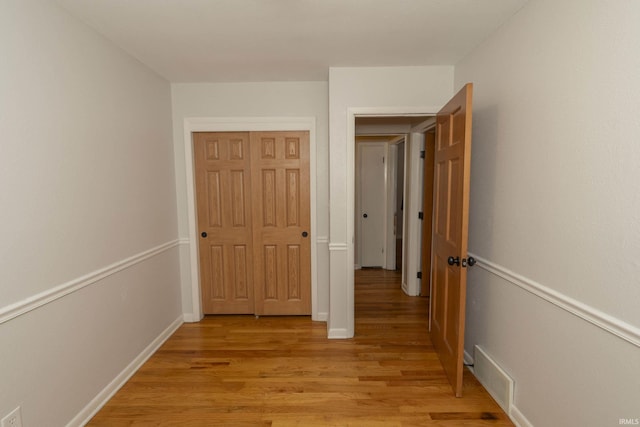 hall with light wood-type flooring