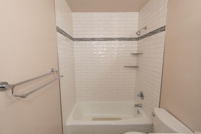 bathroom with tiled shower / bath combo and toilet