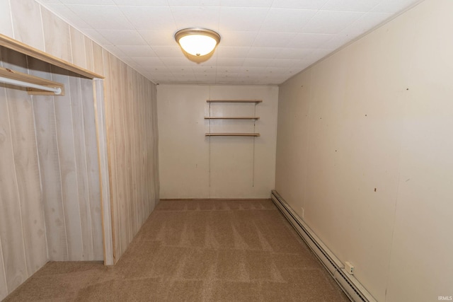 basement with baseboard heating and light carpet