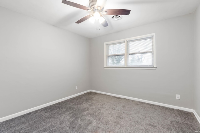 carpeted spare room featuring ceiling fan