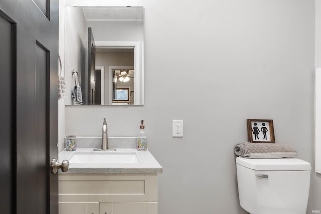 bathroom with ceiling fan, vanity, and toilet