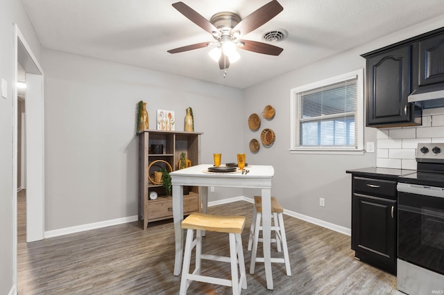 dining room featuring ceiling fan and wood-type flooring