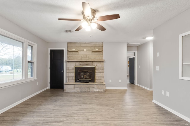 unfurnished living room with wood-type flooring and a textured ceiling