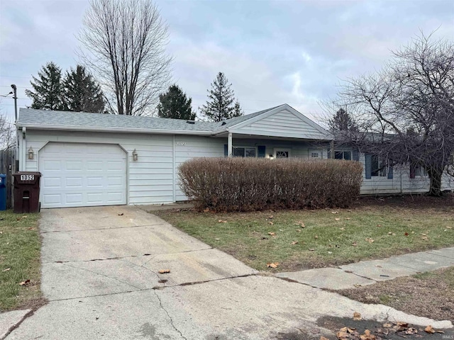 view of front of home with a garage and a front lawn