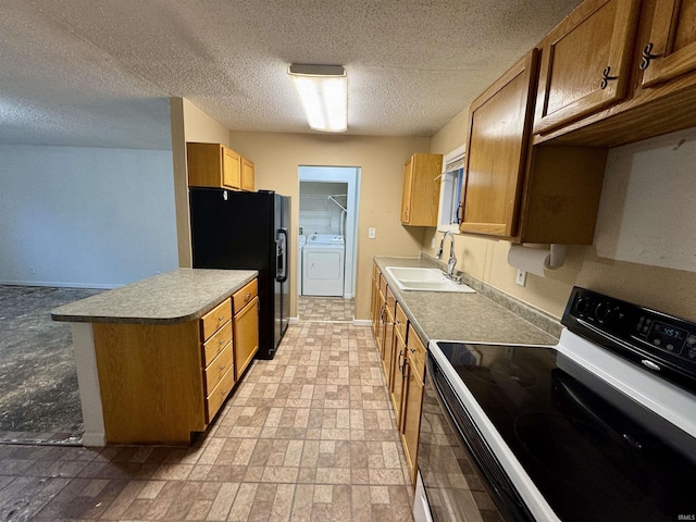 kitchen featuring black appliances, washer / dryer, sink, and a textured ceiling