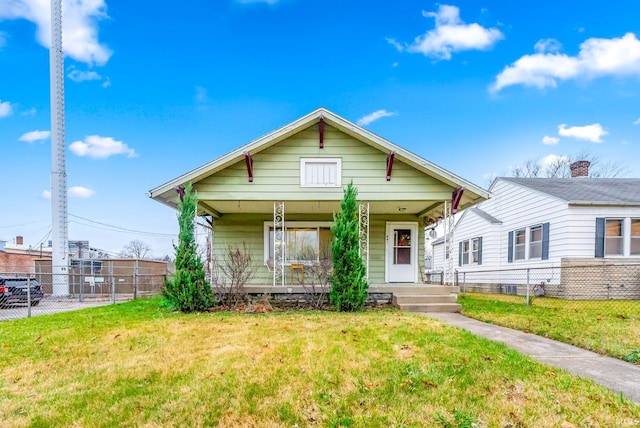 bungalow-style home featuring a front yard and covered porch