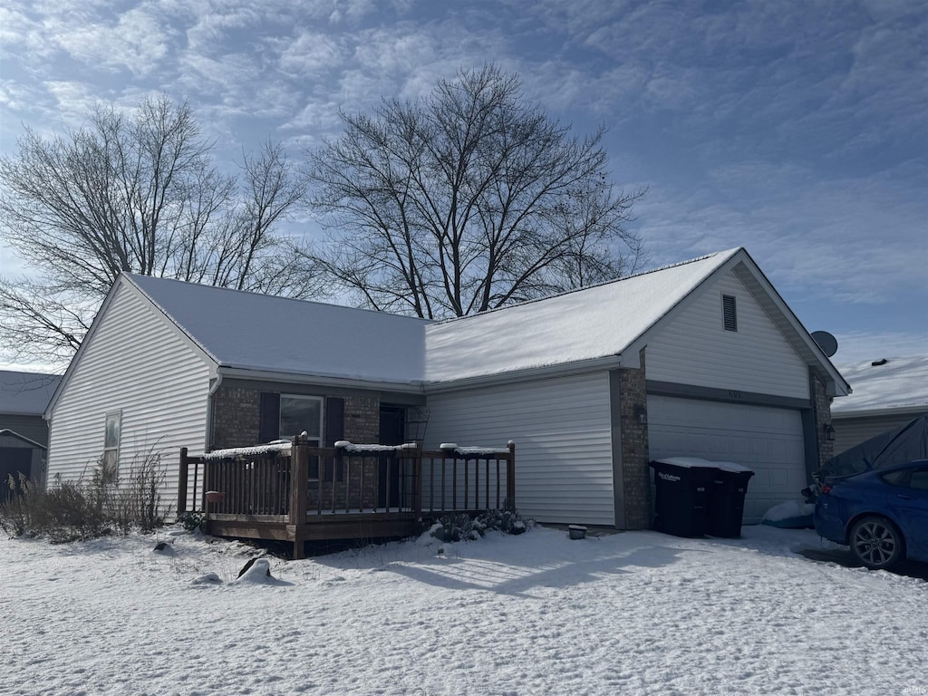 ranch-style home with a garage and a deck