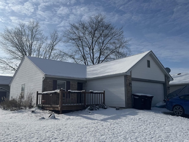 ranch-style home with a garage and a deck