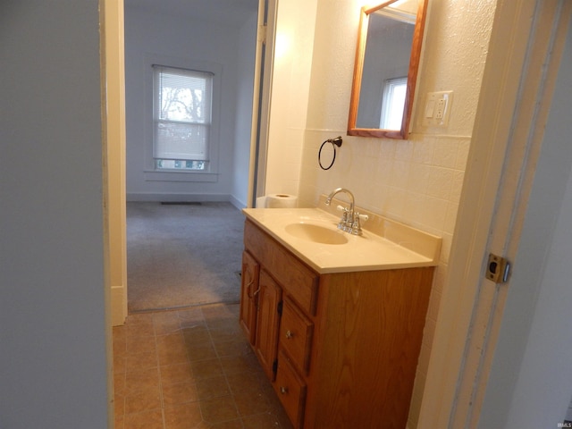 bathroom with tile patterned floors and vanity