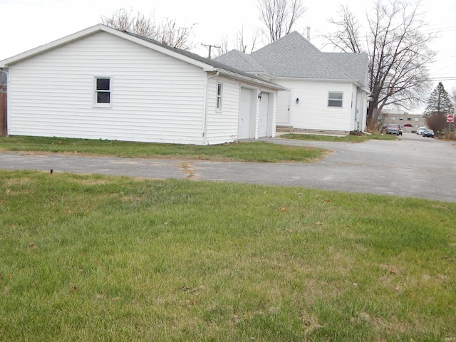 view of home's exterior with a yard and a garage