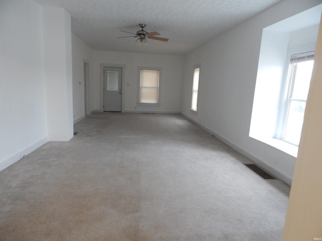 unfurnished room featuring ceiling fan and light colored carpet