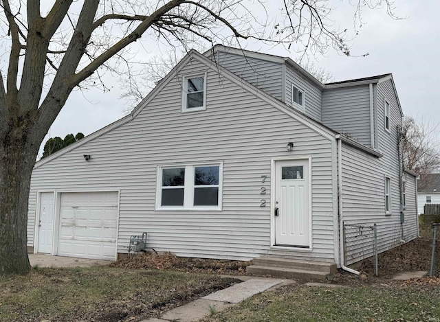 rear view of property featuring a garage