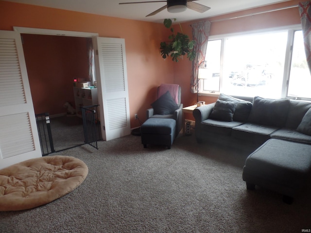 living room featuring carpet and ceiling fan