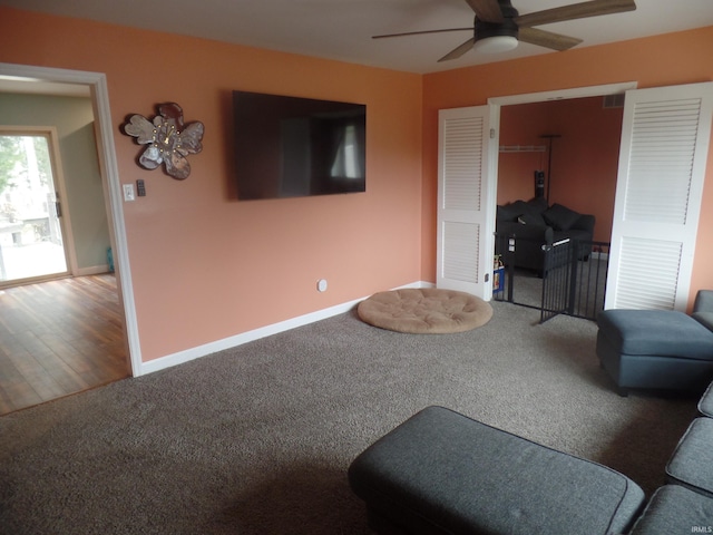 living room with hardwood / wood-style flooring and ceiling fan