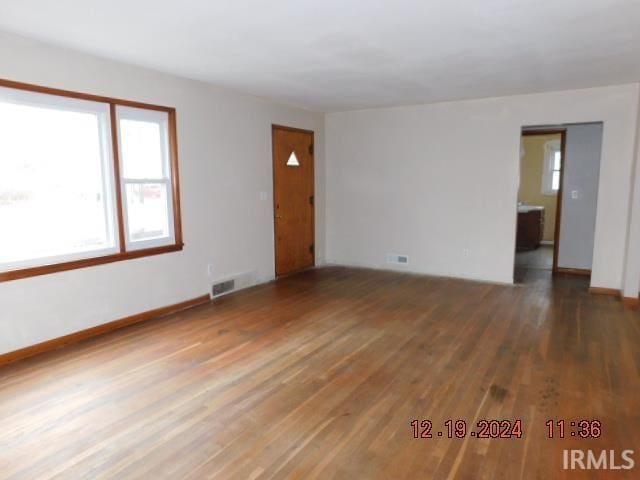 unfurnished room with dark hardwood / wood-style floors