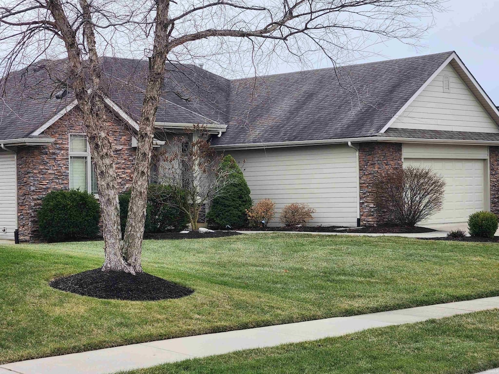 ranch-style house with a front yard and a garage