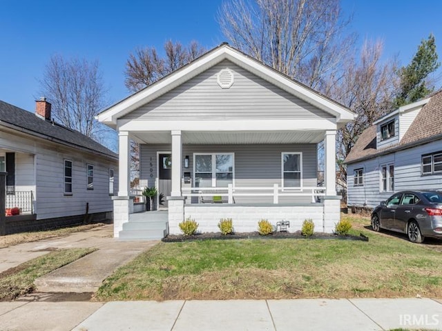 view of front of property with a porch and a front lawn