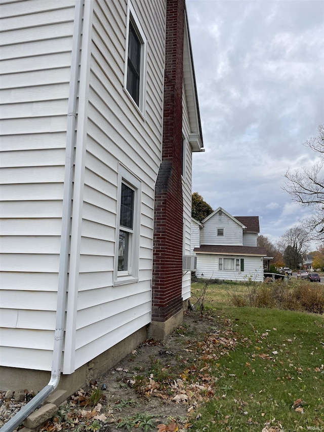 view of home's exterior with a lawn