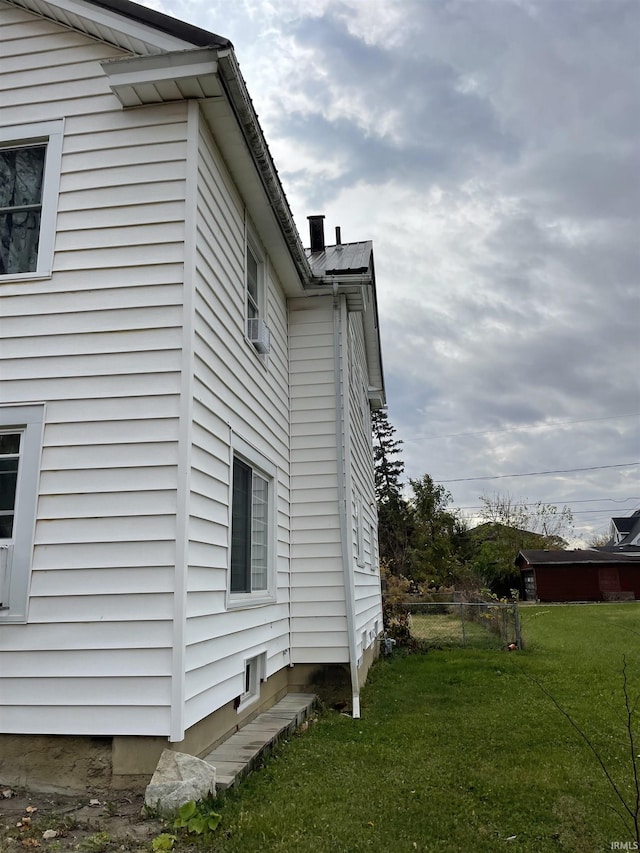 view of property exterior featuring a lawn and cooling unit