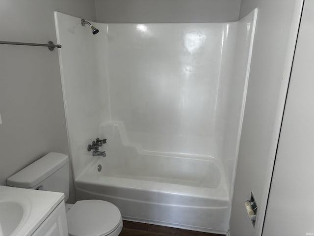 full bathroom featuring hardwood / wood-style floors, vanity, bathing tub / shower combination, and toilet