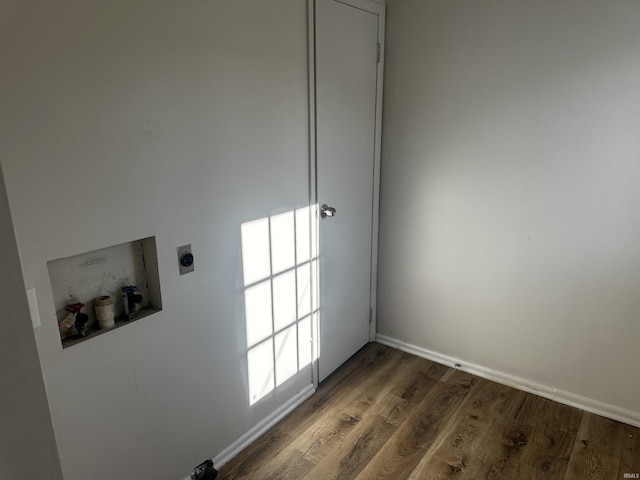 laundry room featuring hookup for a washing machine, dark hardwood / wood-style flooring, and hookup for an electric dryer