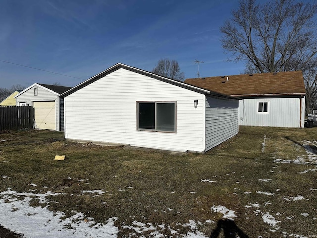 view of snow covered exterior with a lawn and a garage