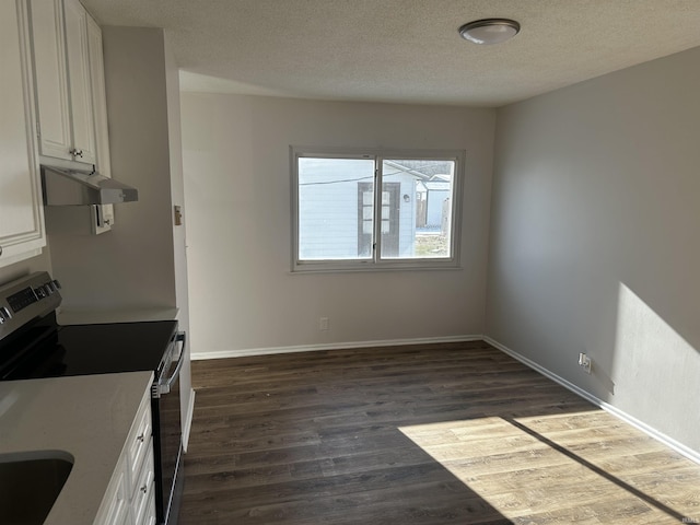 kitchen featuring a textured ceiling, stainless steel electric range, white cabinetry, and dark wood-type flooring