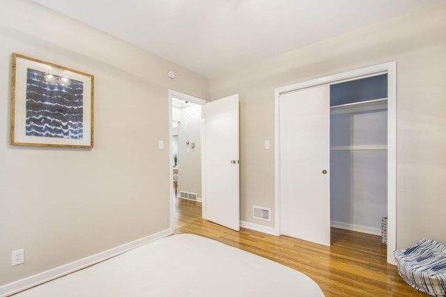 bedroom featuring hardwood / wood-style flooring and a closet