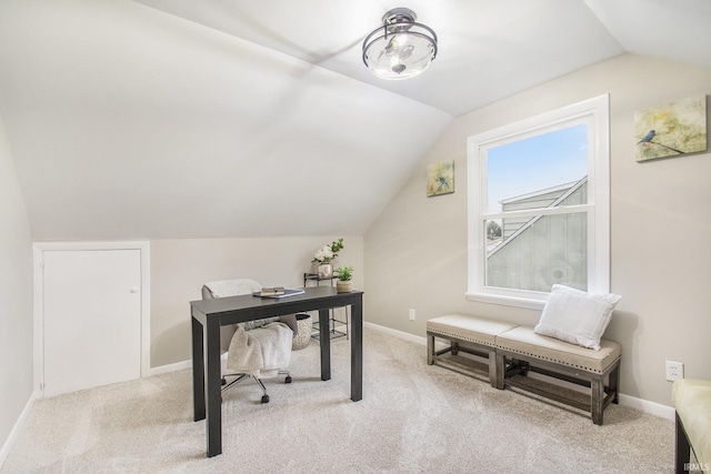 carpeted office space with vaulted ceiling