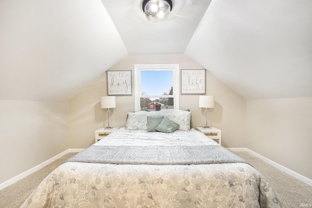 carpeted bedroom featuring lofted ceiling