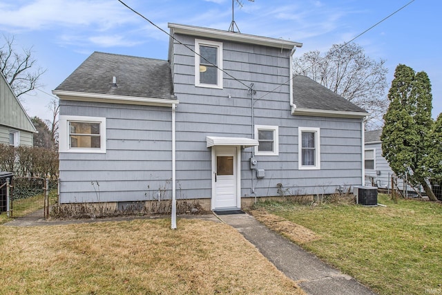 exterior space featuring central AC unit and a front yard